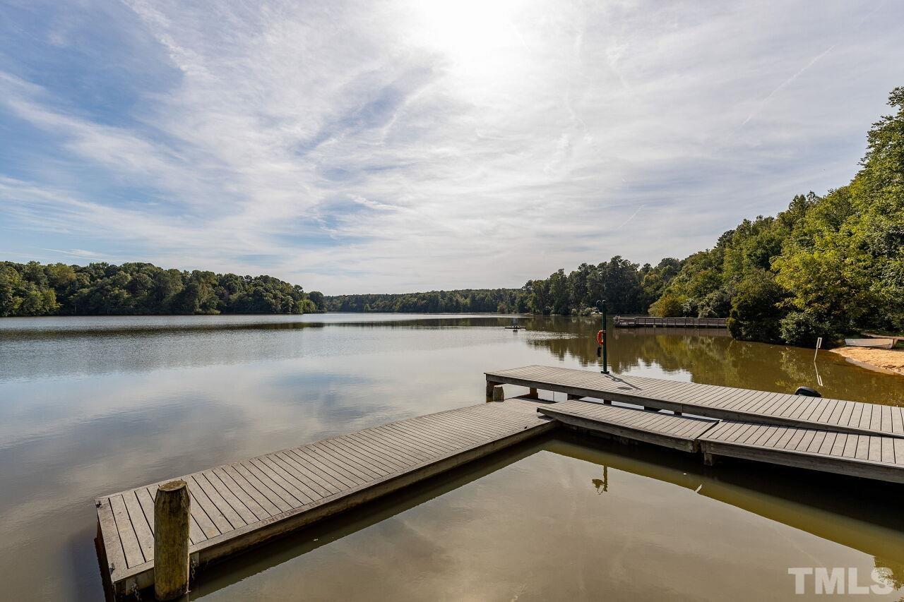 208 West Savannah Ridge Road, Unit 208 Holly Springs, NC 27540 - Photo 30 of 30 a view of a lake with a table and chairs