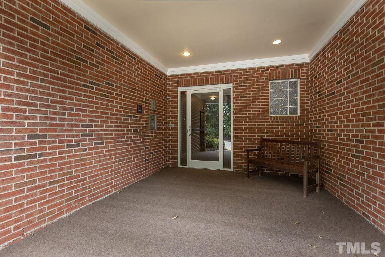 208 West Savannah Ridge Road, Unit 208 Holly Springs, NC 27540 - Photo 3 of 30 a view of an empty room with a brick wall