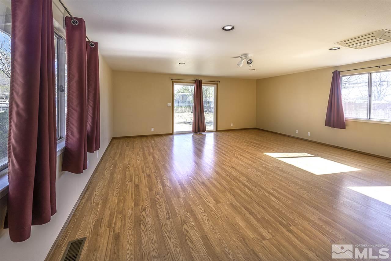 165 Ring Road Dayton, NV 89403 - Photo 8 of 19 an empty room with wooden floor and windows