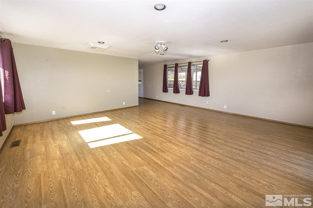 165 Ring Road Dayton, NV 89403 - Photo 10 of 19 an empty room with wooden floor and windows