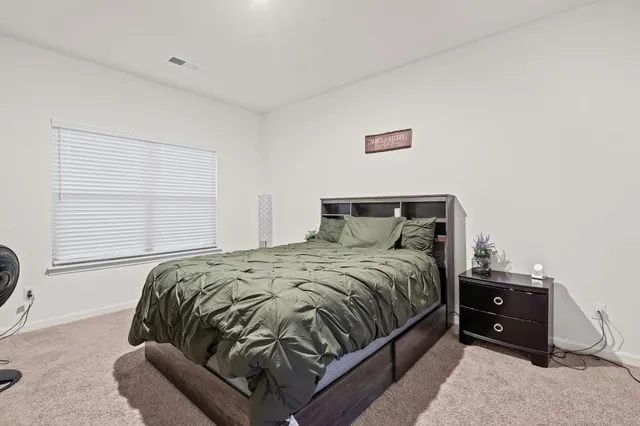 a bedroom with a bed and a window