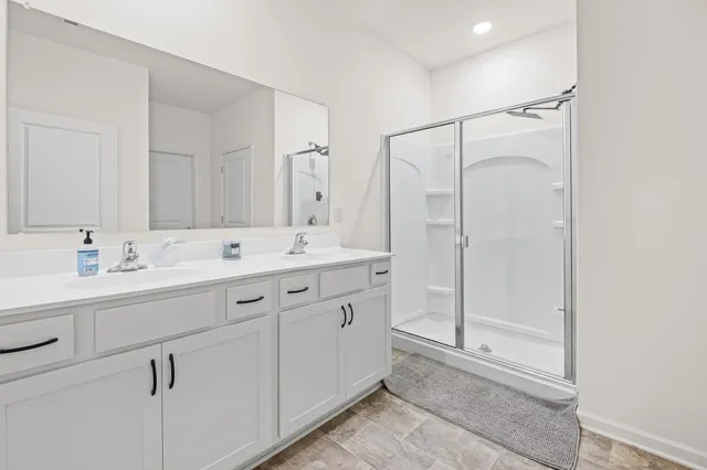 a bathroom with a shower sink and mirror