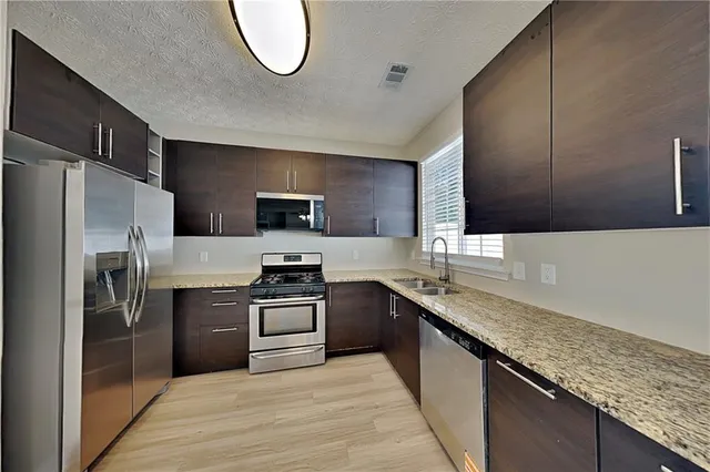 an empty room with closet and a chandelier fan