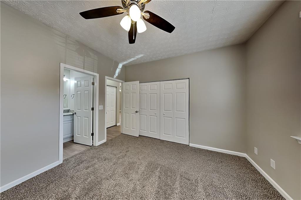 274 Windcroft Lane Northwest Acworth, GA 30101 - Photo 4 of 16 an empty room with closet and a chandelier fan