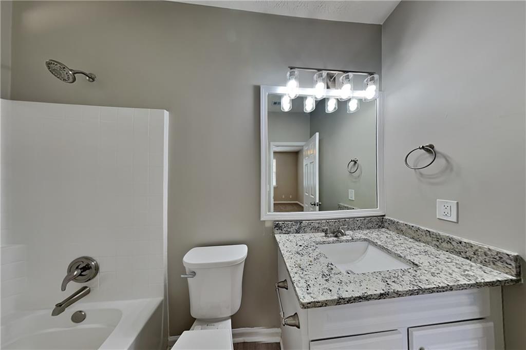 274 Windcroft Lane Northwest Acworth, GA 30101 - Photo 6 of 16 a bathroom with a granite countertop sink and a mirror