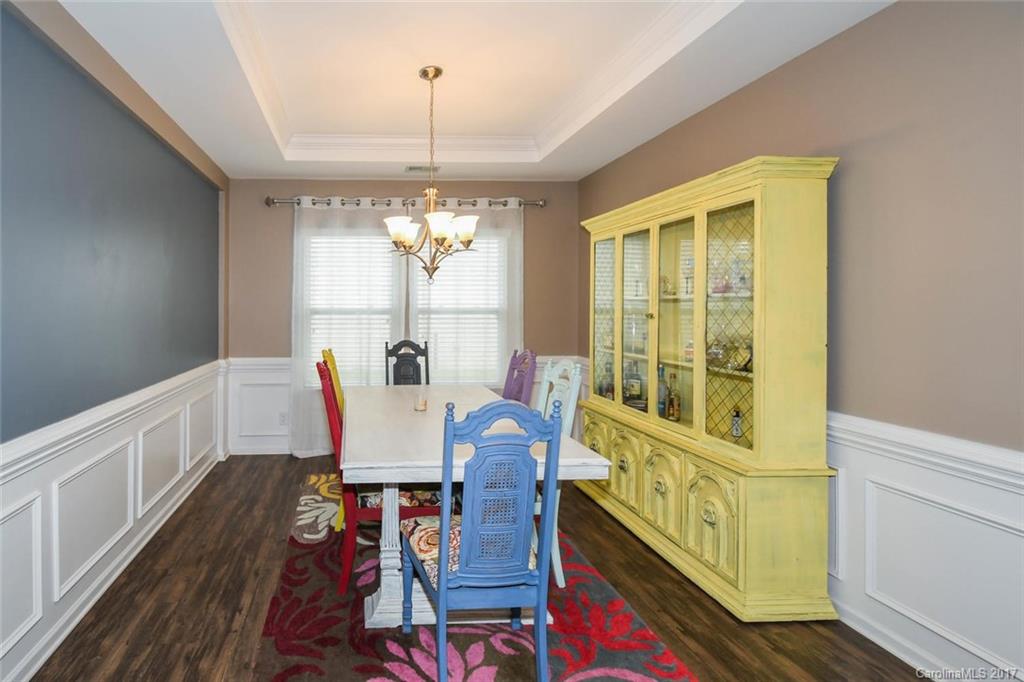 79457 Ridgehaven Road Lancaster, SC 29720 - Photo 4 of 24 a view of a dining room with furniture a chandelier and wooden floor