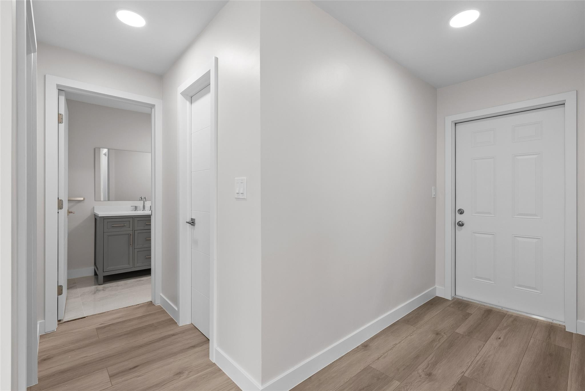 1150 East Sample Road, Unit 202 Pompano Beach, FL 33064 - Photo 7 of 20 a view of hallway with a sink and wooden floor