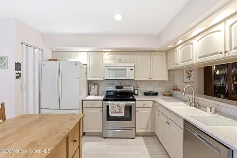 a kitchen with a sink stove and refrigerator