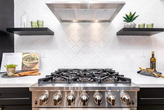 a stove top oven sitting inside of a kitchen