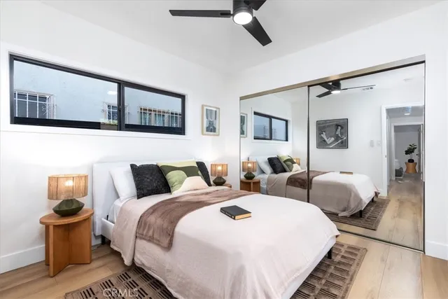 a bedroom with two beds and a painting on the wall