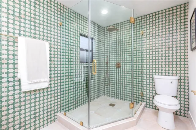 a bathroom with a toilet and a shower