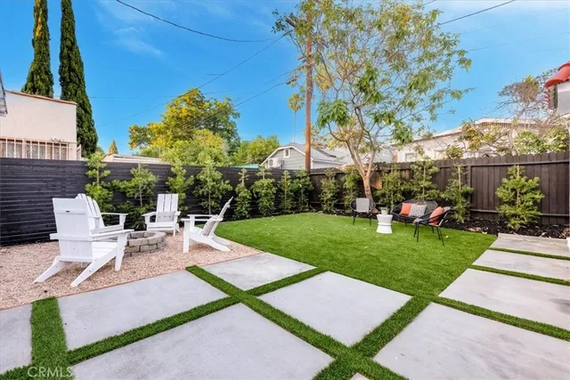 a view of a backyard with sitting area