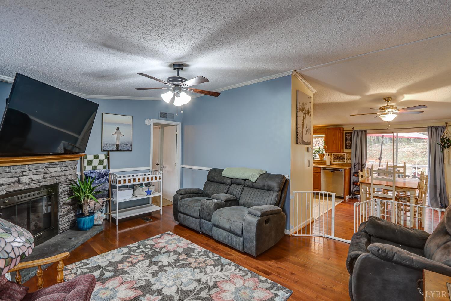 2019 Country Club Road Hurt, VA 24563 - Photo 12 of 39 a living room with furniture flat screen tv and a fireplace