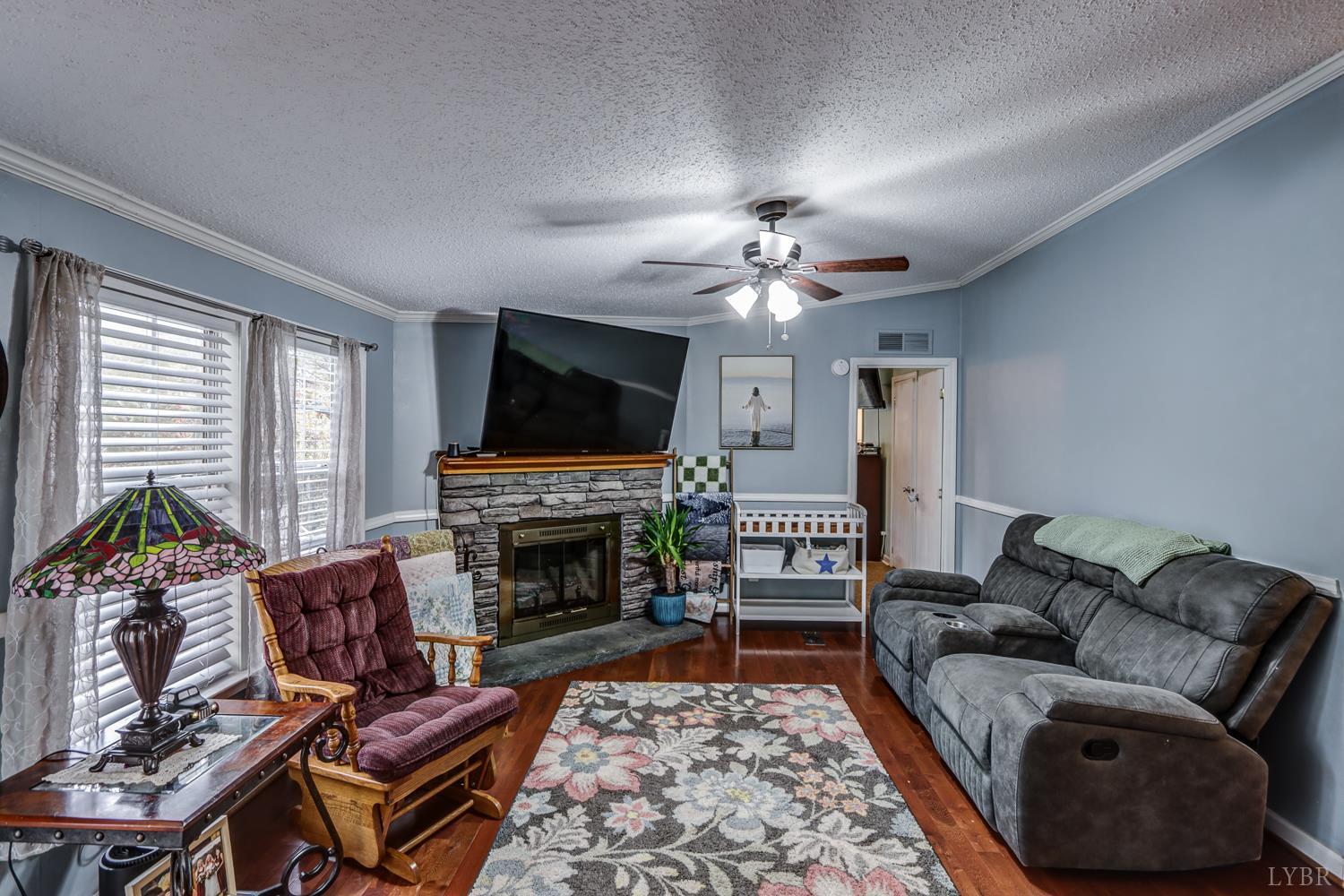 2019 Country Club Road Hurt, VA 24563 - Photo 14 of 39 a living room with furniture a flat screen tv and a fireplace