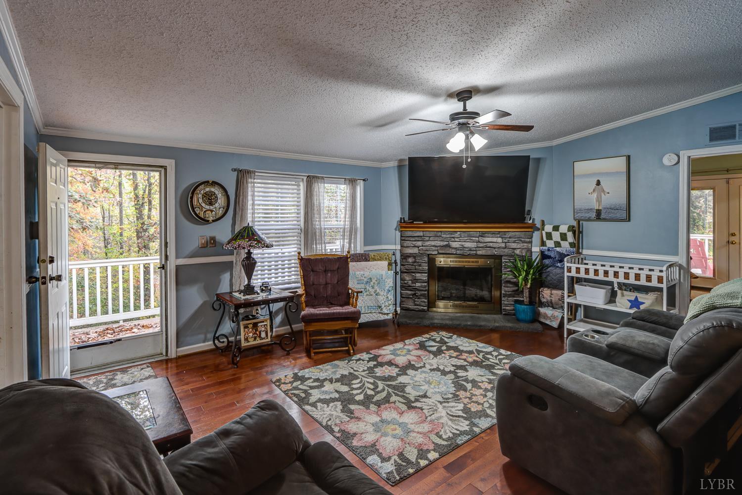 2019 Country Club Road Hurt, VA 24563 - Photo 15 of 39 a living room with furniture a fireplace and a flat screen tv