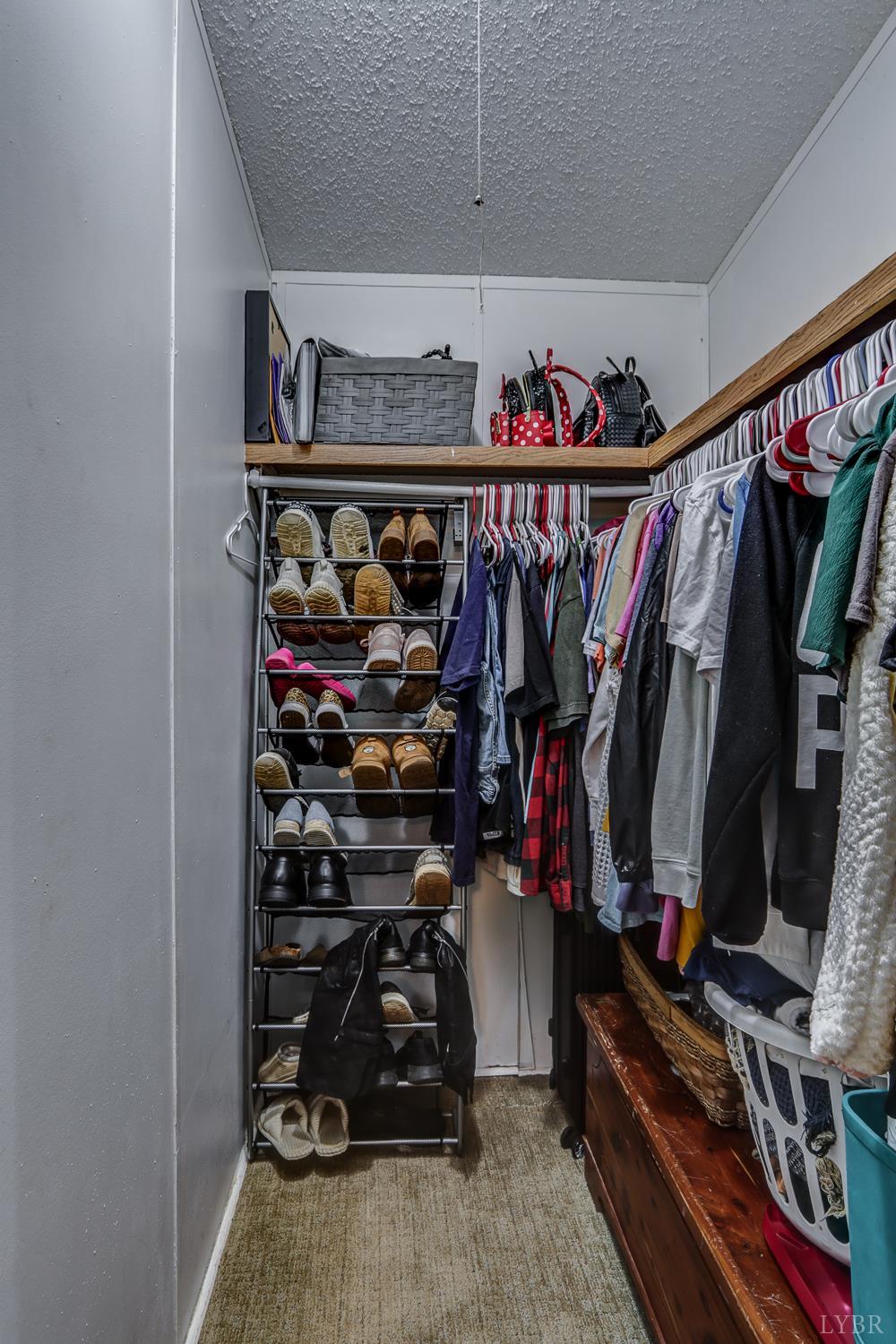 2019 Country Club Road Hurt, VA 24563 - Photo 21 of 39 a view of walk in closet with clothes and shoes