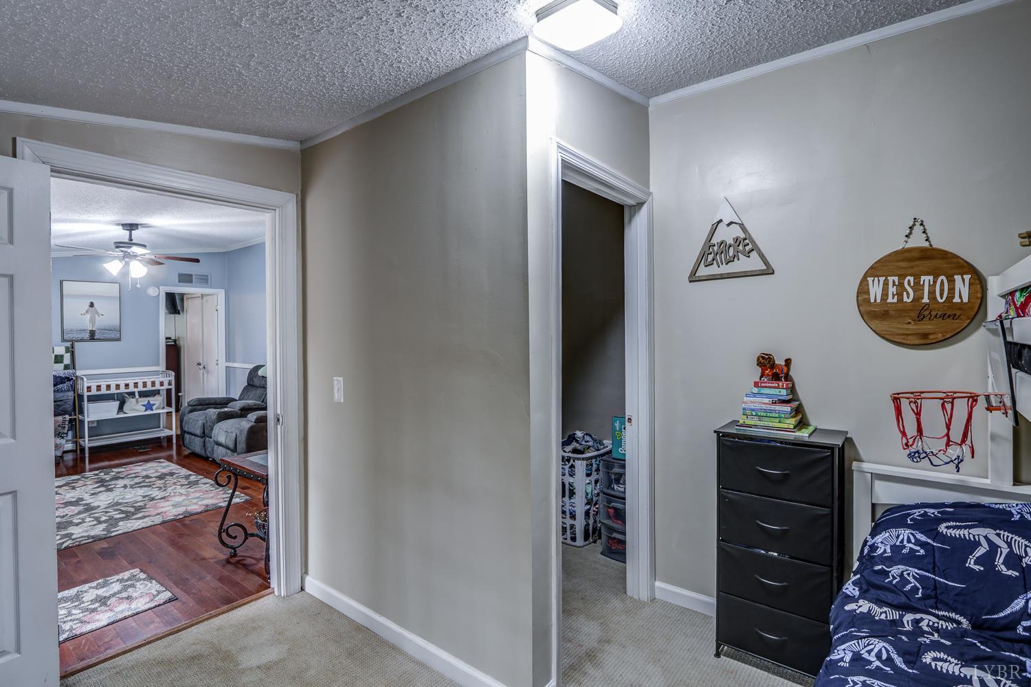 2019 Country Club Road Hurt, VA 24563 - Photo 24 of 39 a bedroom with a bed and a lamp on dresser