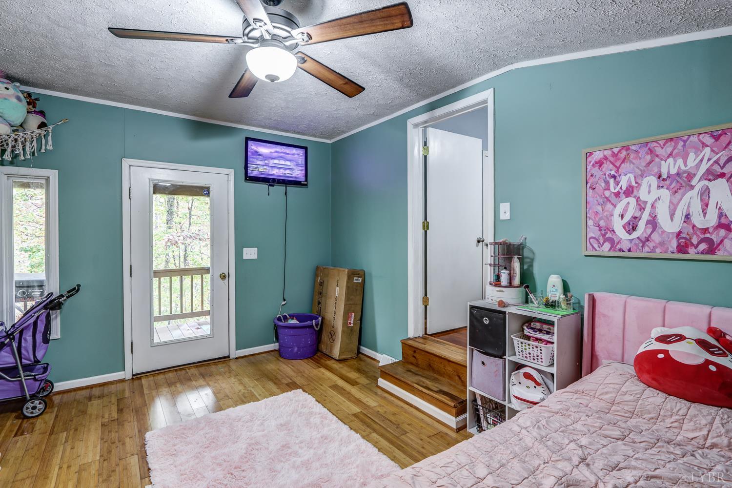 2019 Country Club Road Hurt, VA 24563 - Photo 26 of 39 a bedroom with a bed and a chandelier