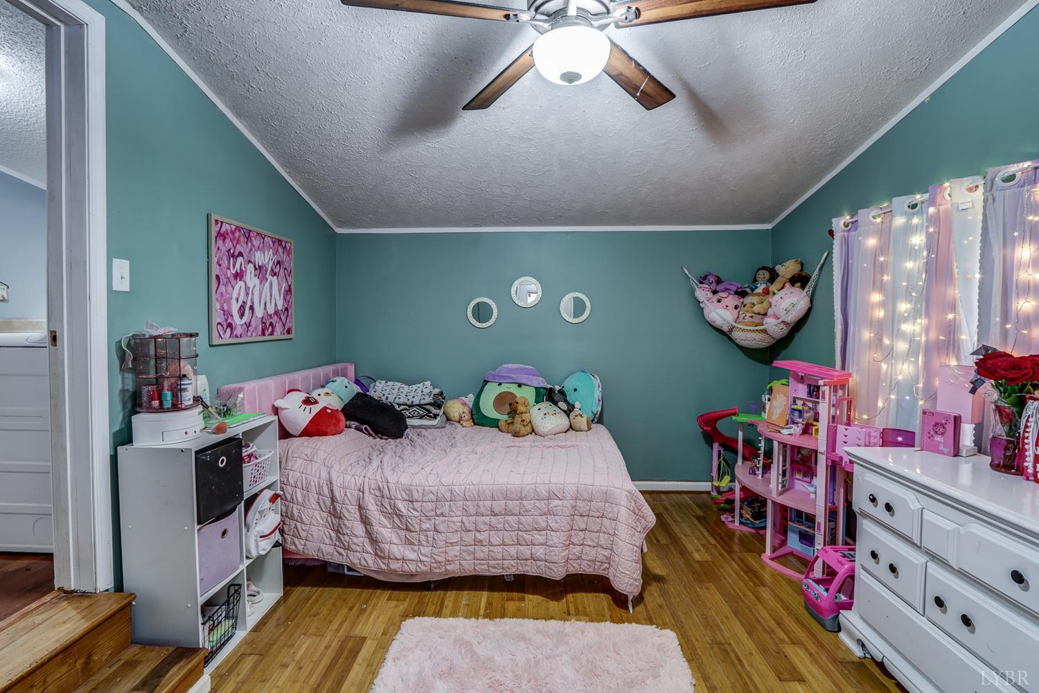 2019 Country Club Road Hurt, VA 24563 - Photo 27 of 39 a bedroom with bed and a chandelier