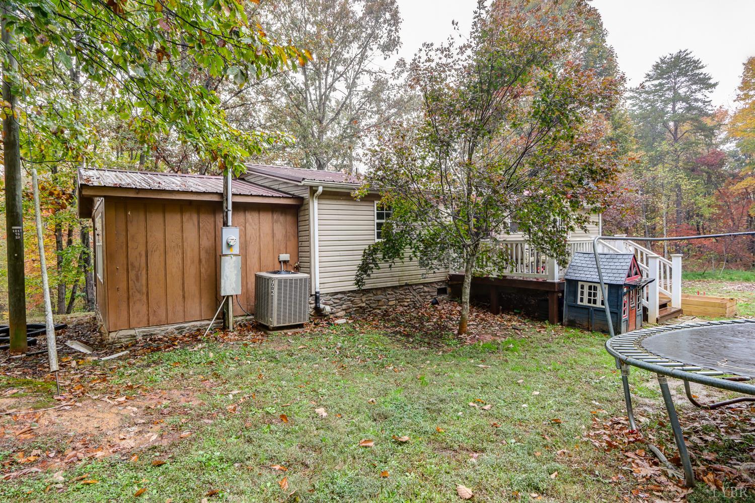 2019 Country Club Road Hurt, VA 24563 - Photo 33 of 39 a view of backyard with wooden fence and a large tree