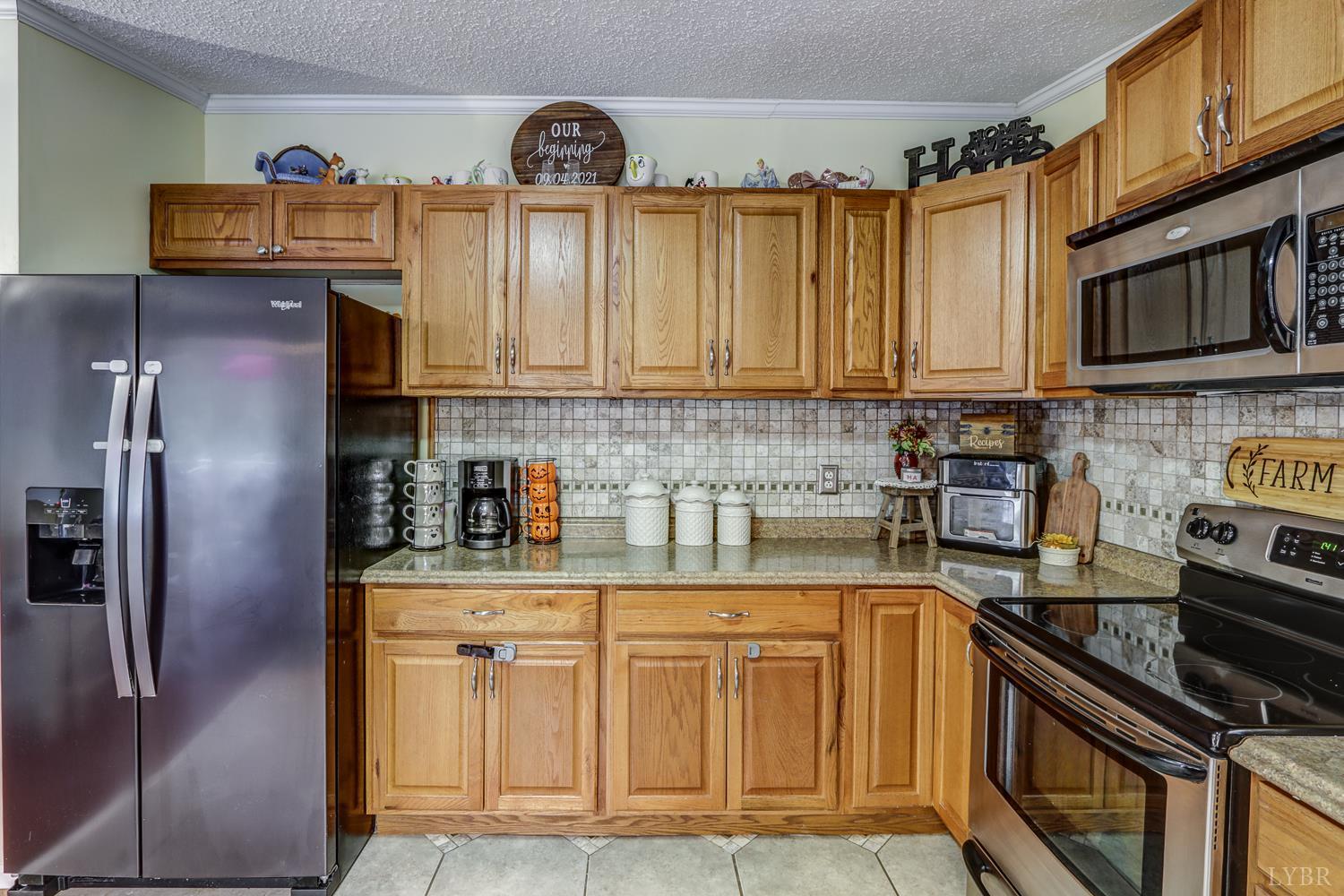 2019 Country Club Road Hurt, VA 24563 - Photo 6 of 39 a kitchen with stainless steel appliances granite countertop a refrigerator a stove and a sink