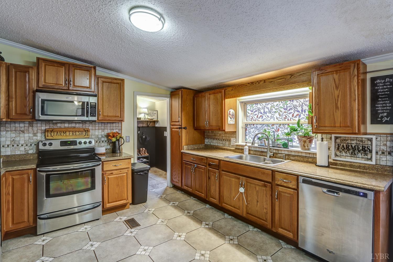 2019 Country Club Road Hurt, VA 24563 - Photo 9 of 39 a kitchen with stainless steel appliances granite countertop a stove sink and microwave