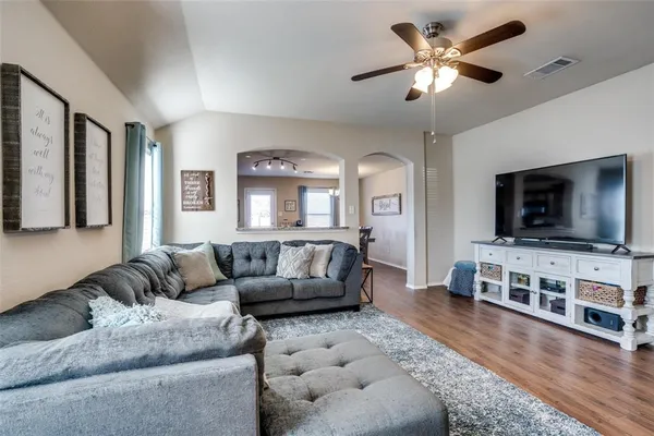 a living room with furniture and a flat screen tv