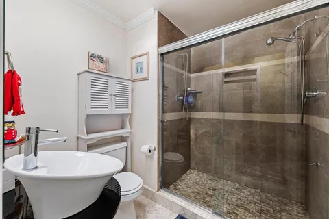 a bathroom with a sink toilet and shower