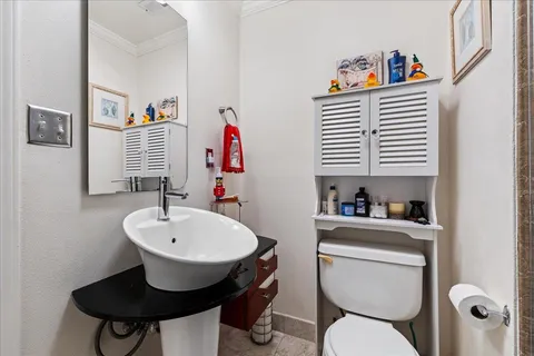 a bathroom with a toilet a sink and a mirror