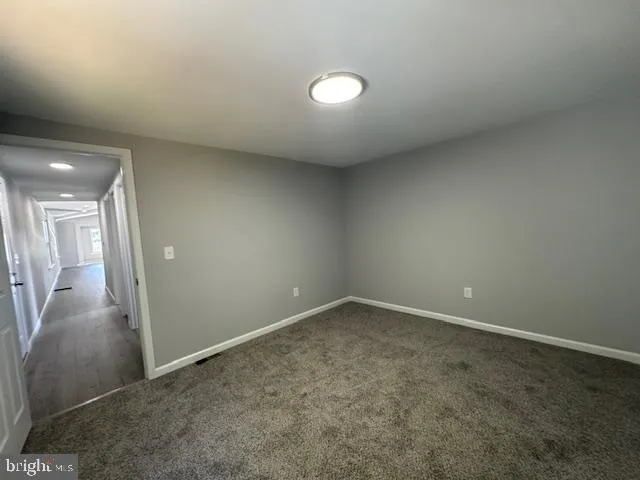 a view of a kitchen with a sink and cabinets