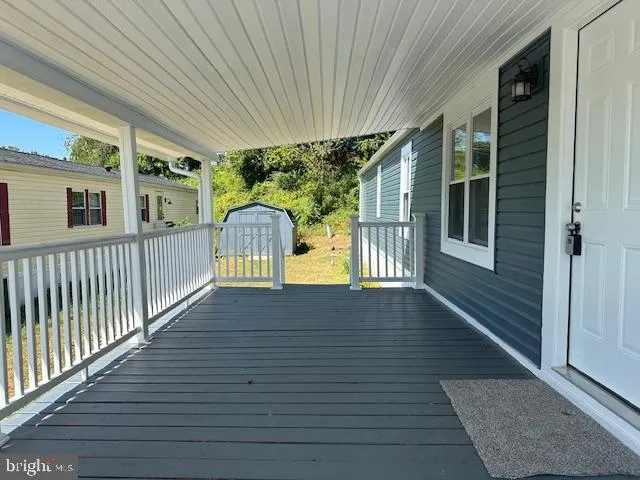 a open kitchen with white cabinets wooden floor and a fireplace