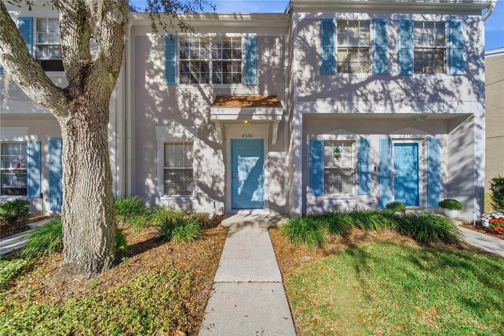 8530 Hunters Key Circle Tampa, FL 33647 - Photo 1 of 18 a view of a brick house with many windows next to a yard