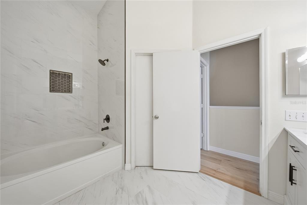 8530 Hunters Key Circle Tampa, FL 33647 - Photo 16 of 18 a white bath tub sitting next to a shower