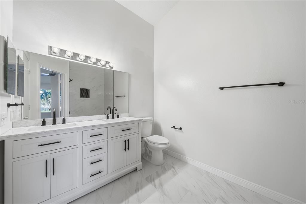 8530 Hunters Key Circle Tampa, FL 33647 - Photo 17 of 18 a spacious bathroom with a double vanity sink a mirror and a toilet