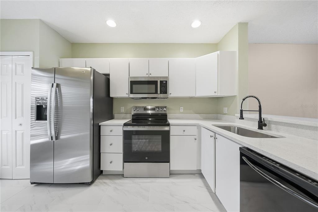 8530 Hunters Key Circle Tampa, FL 33647 - Photo 3 of 18 a kitchen with stainless steel appliances granite countertop a sink stove and refrigerator
