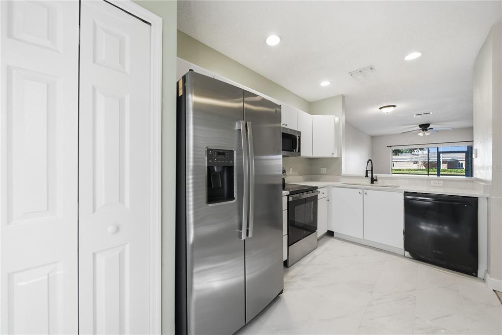 8530 Hunters Key Circle Tampa, FL 33647 - Photo 4 of 18 a kitchen with cabinets and stainless steel appliances