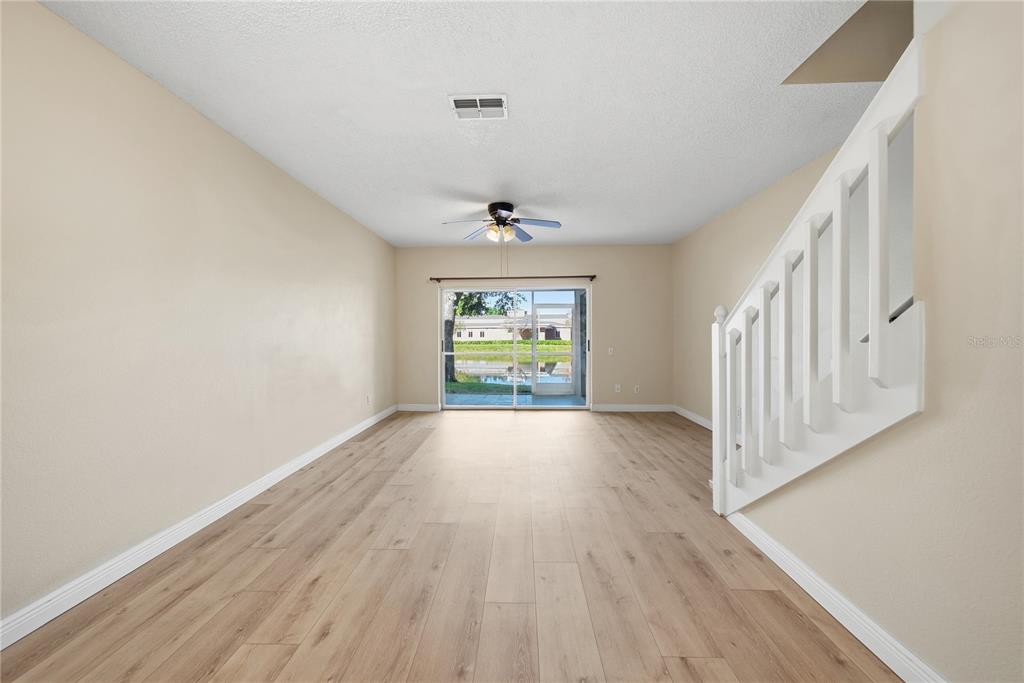 8530 Hunters Key Circle Tampa, FL 33647 - Photo 6 of 18 wooden floor in an empty room with a window