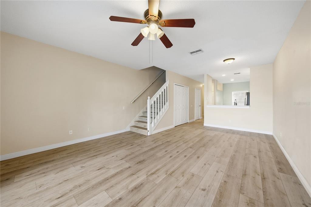 8530 Hunters Key Circle Tampa, FL 33647 - Photo 7 of 18 a view of an empty room with window and wooden floor