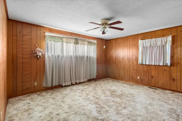 an empty room with windows and closet