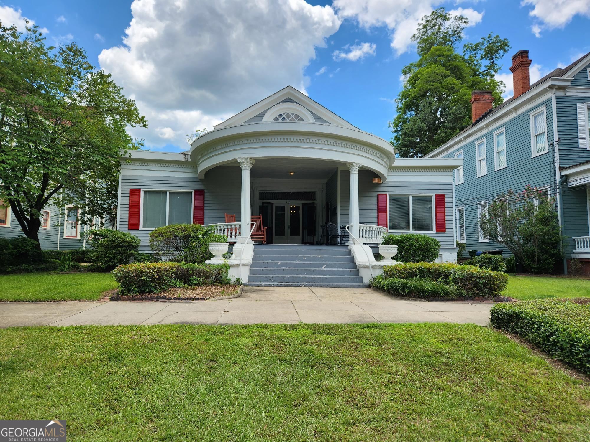 717 Broadway, Unit 8 Columbus, GA 31901 - Photo 1 of 1 a front view of a house with a yard and potted plants