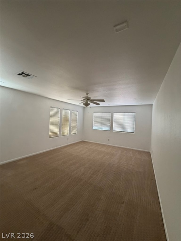 3862 Landing Ridge Place Las Vegas, NV 89135 - Photo 8 of 26 A quiet retreat with comfortable carpeting and a cooling ceiling fan awaits.