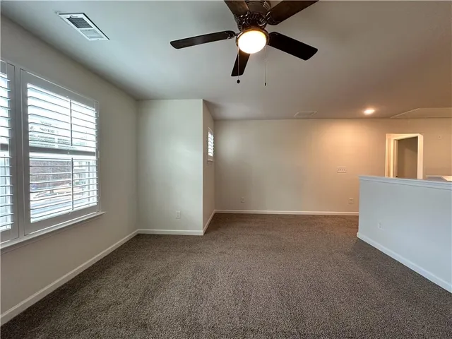 a view of a room with rack on the wall and a window