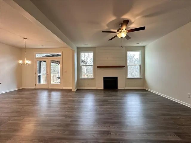 a large kitchen with stainless steel appliances granite countertop a sink and dishwasher a stove with wooden floors