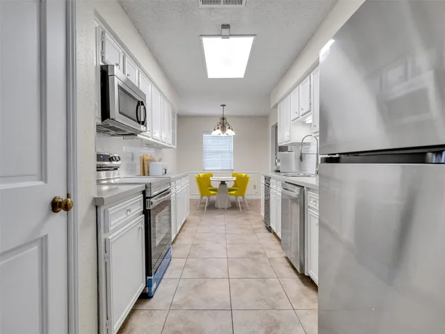 a kitchen with stainless steel appliances a refrigerator and a stove