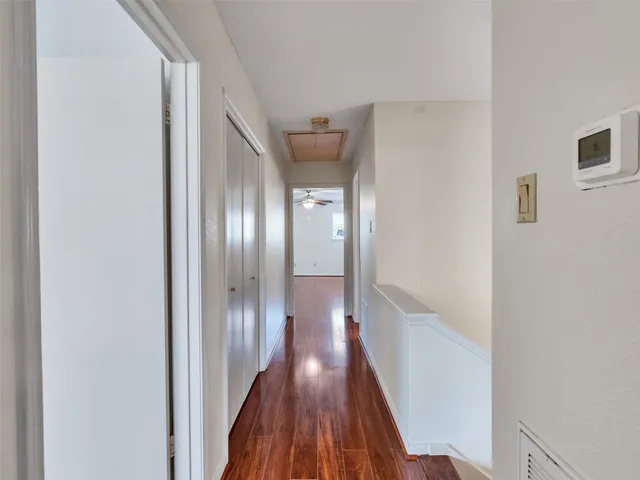 a view of a hallway with wooden floor