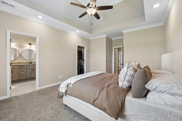 a bedroom with a bed and a chandelier