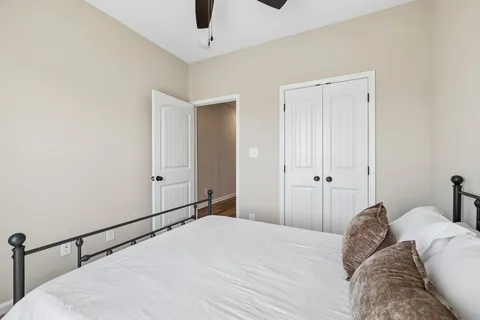 a view of a bedroom with a bed and a cabinet