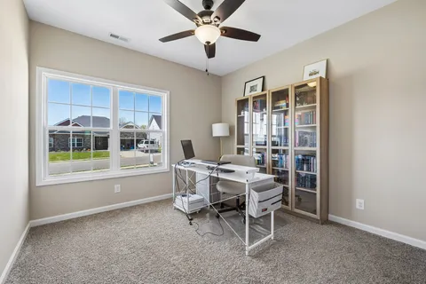 a dining room with furniture and window
