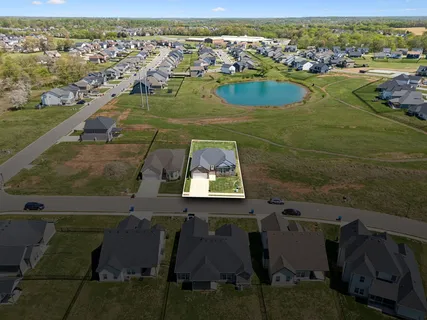 an aerial view of residential houses with outdoor space