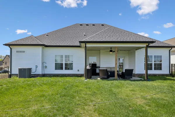 a front view of a house with a yard and porch